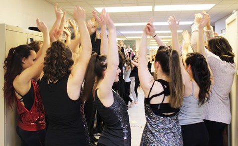 Dancers gather before show for motivation (bottom center).