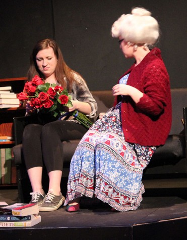 Senior Victoria Snyder (right) gives freshman Erin Whyte (left) a bouquet of roses in “Love? Maybe.”