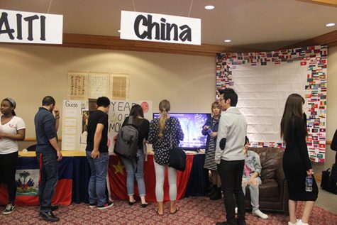 Festival attendees look at a booth about China. 
