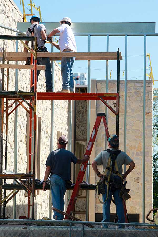 Construction crews work on the exterior of the Engineering and Science building , building natural-light study areas onto what was the front wall.