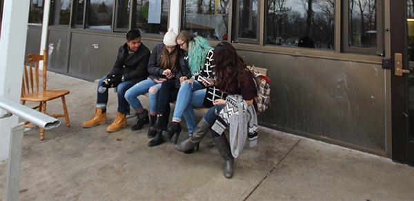 Hemlock residents mingle outside their hall, where a resident assistant has been charged with selling drugs and alcohol to freshmen.