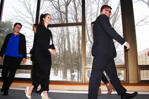 Students model proper business outfits by walking a runway in the Student Union last Wednesday.