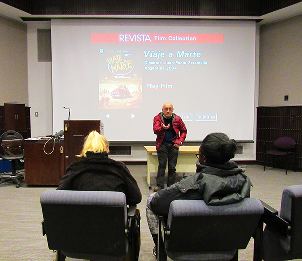 Professor Alvaro Bernal speaks to seniors Molly Dupin (left) and Erica Enarusai before the first film, Viaje a Marte, played in 131 Blackington Hall.