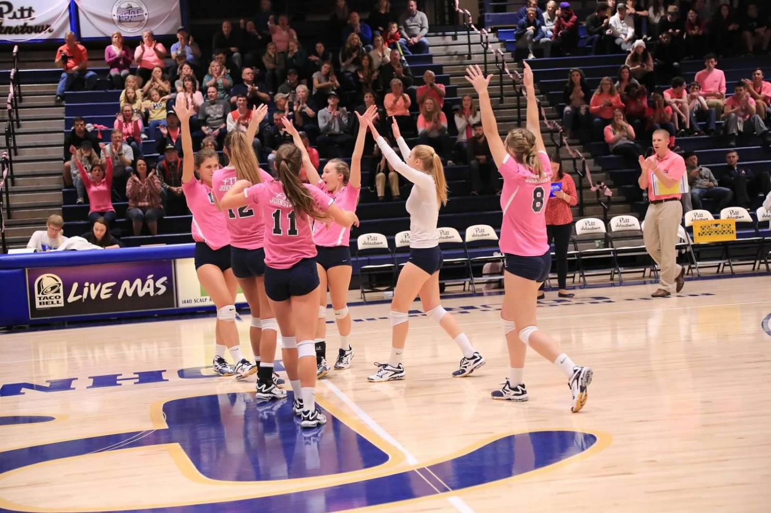 Pitt-Johnstown volleyball members celebrate an ace against California (Pa.) Friday night in their annual dig pink game. The Mountain Cats won 3-1, to improve to 20-6 overall and 10-3 in the conference.
