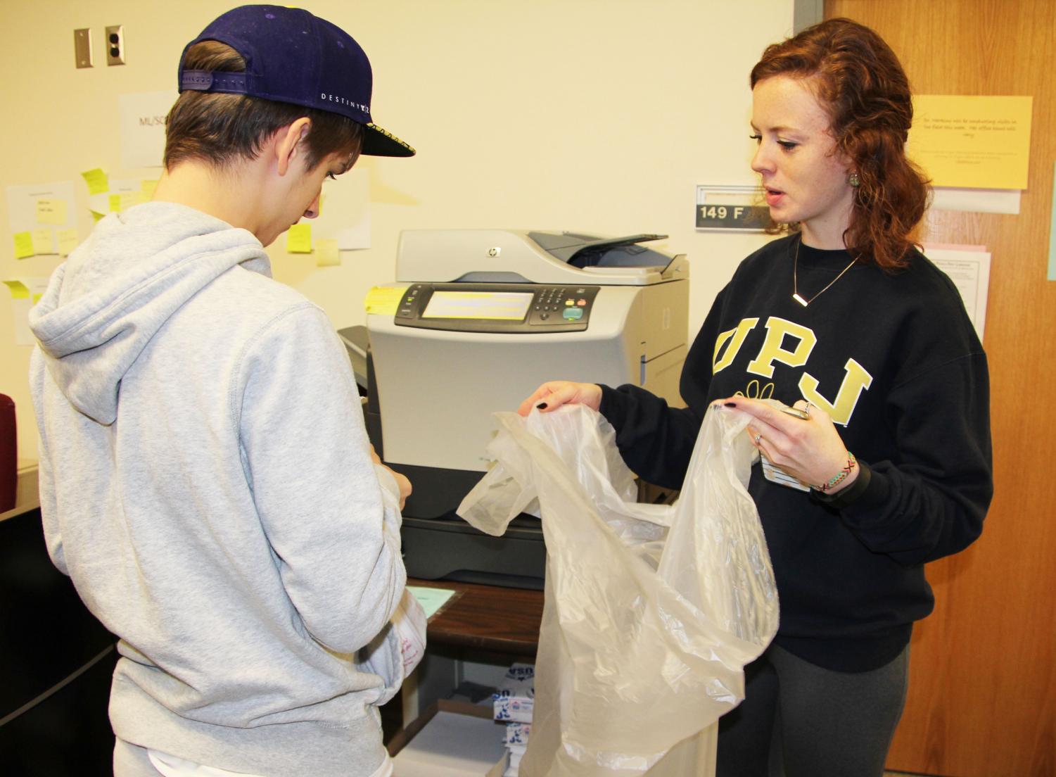 Bridge-transition program student Justin Gorden and Pitt-Johnstown junior Janna Shober collect recycling in Biddle Hall.