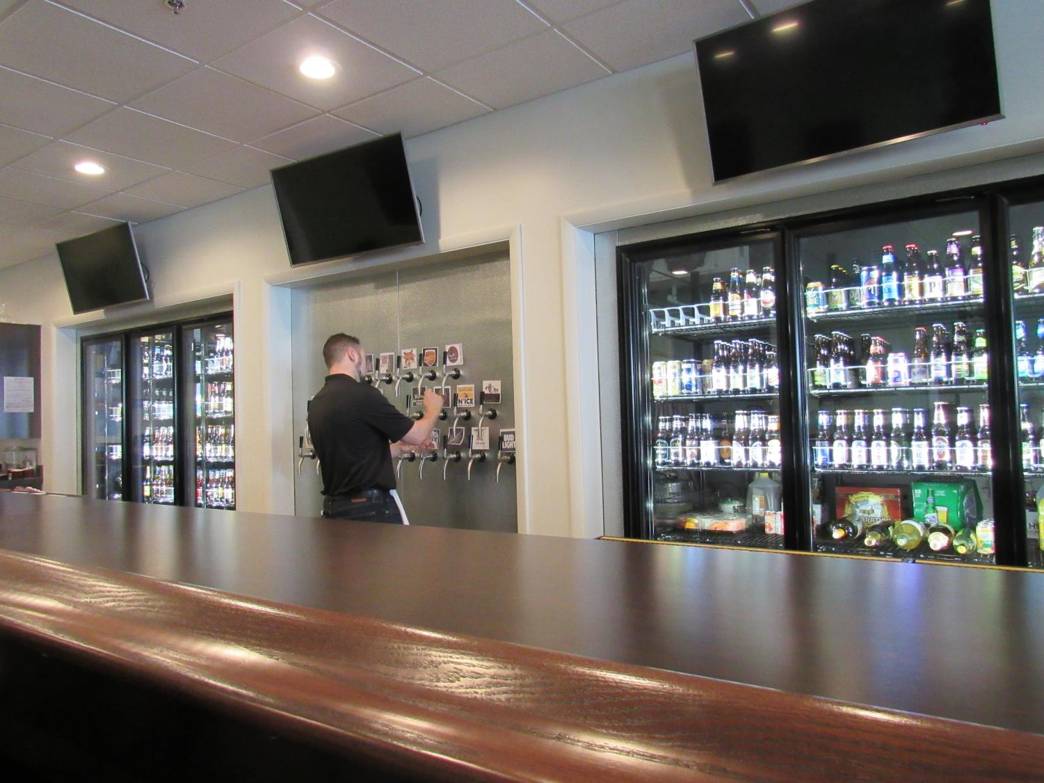 Bartender Devin Layton pours a beer from one of the taps in preparation for the dinner crowd at Tulunes Steak and Alehouse Jan. 30.