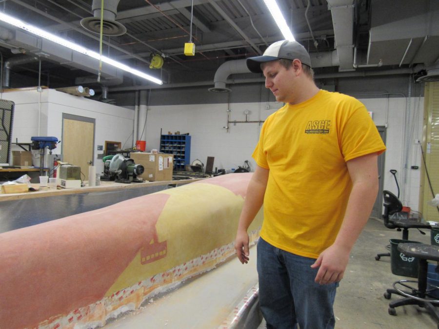 Concrete+Canoe+captain+Justin+Towsey+shows+off+canoe+progress+as+of+early+March.+