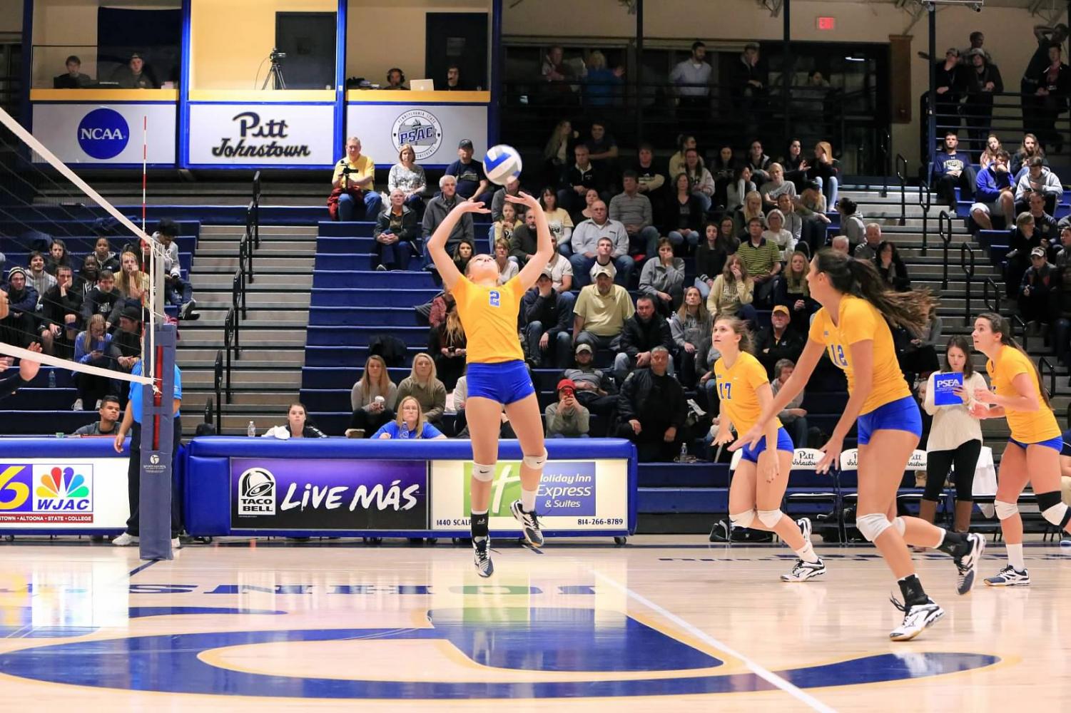 Sophomore J.C. Longeville (center, No. 2) sets the ball up for her teammates at the Sports Center during the conference quarterfinals last season.