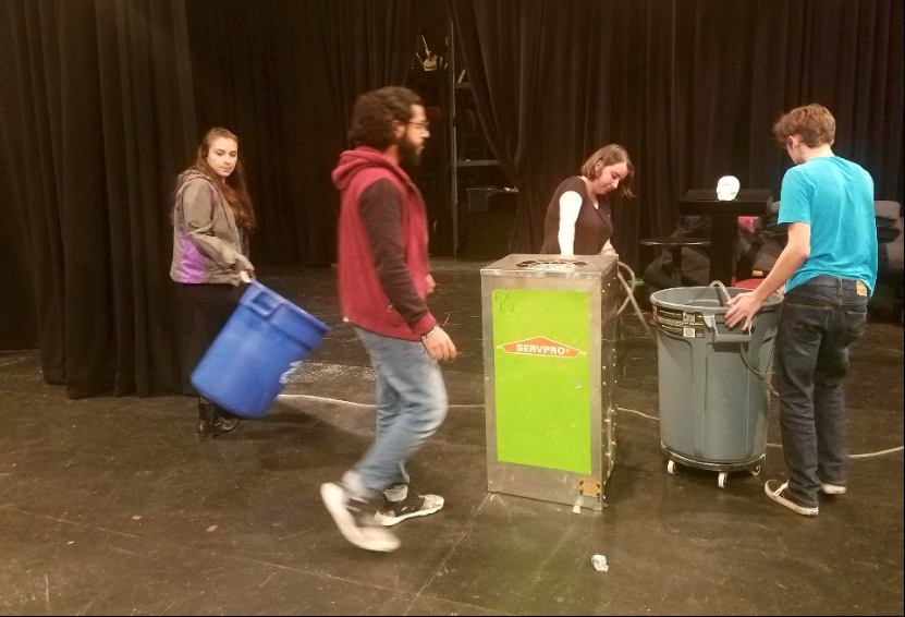 Senior+Erin+Whyte+and+sophomores+Muneer+Al-Busaidi+and+Laken+Burkhardt+clear+dehumidifiers+and+buckets+from+the+studio+theater+before+the+fall+play%E2%80%99s+first+rehaearsal.+