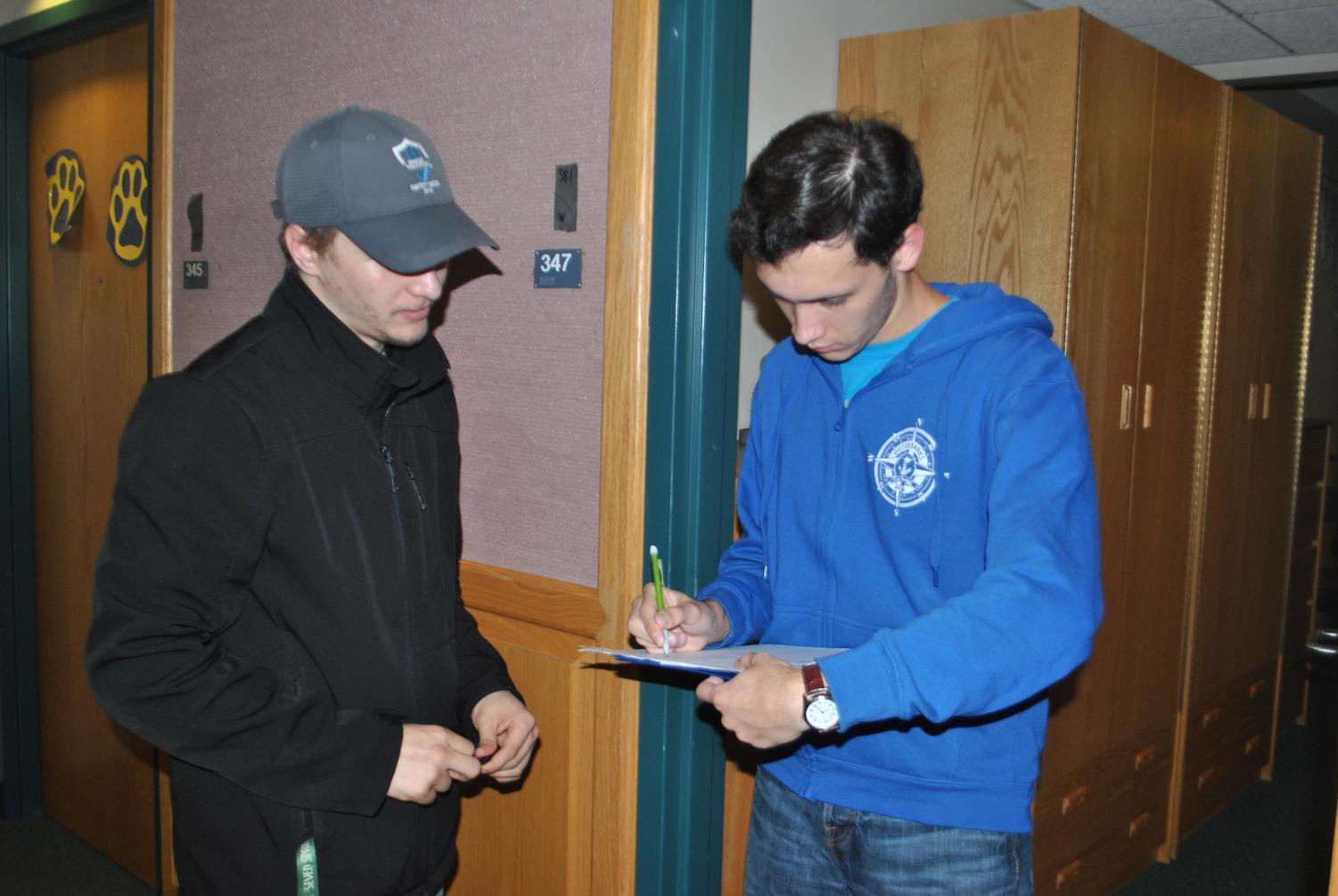Austin Checco has Living/Learning Center resident Dylan Tuttle sign a petition to lobby for Pitt-Johnstown administrators’ attention to living conditions.