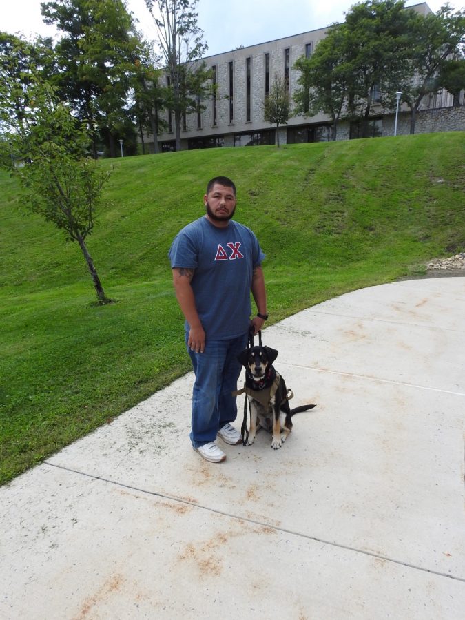 Junior+Justin+Sprinkle+and+his+service+animal%2C+Clyde%2C+standing+outside+the+Nursing+and+Health+Sciences+building+Aug.+30.
