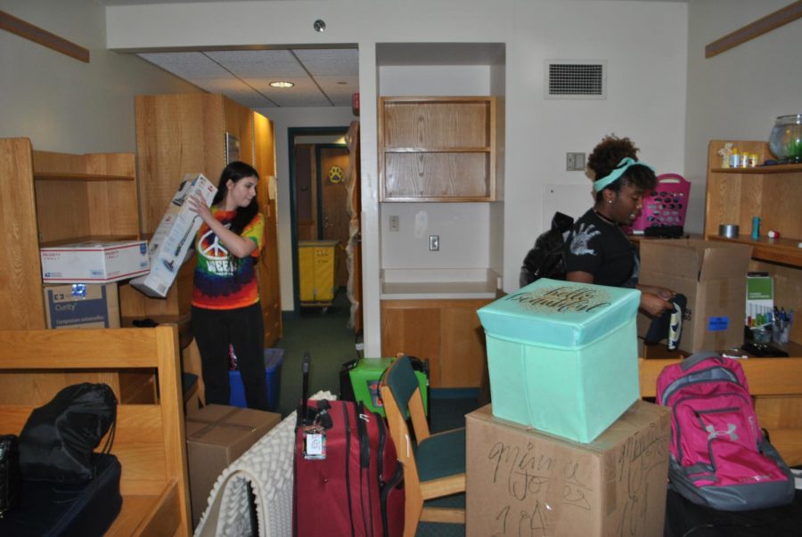 Sophomores+Brittney+Cesari+%28left%29+and+Minnie+Jones+%28right%29+pack+their+belongings+Oct.+7+out+of+their+first-floor+Living%2FLearning+Center+room.+