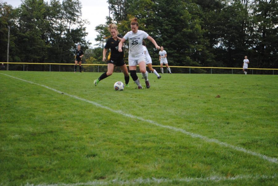 Abby+LaDuke+%28center%2C+white%29+battles+with+a+Millersville+soccer+player+for+ball+control+Sept.+8+at+the+Soccer+Field.+