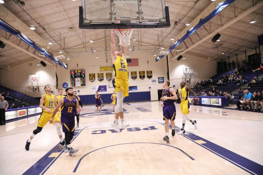 Freshman+Caiden+Landis+%2815%29+dunks+the+basketball+in+a+game+against+Carlow+University+on+Nov.+28+at+the+Sports+Center.+The+team+dominated%2C+the+game%2C+winning+129-69.