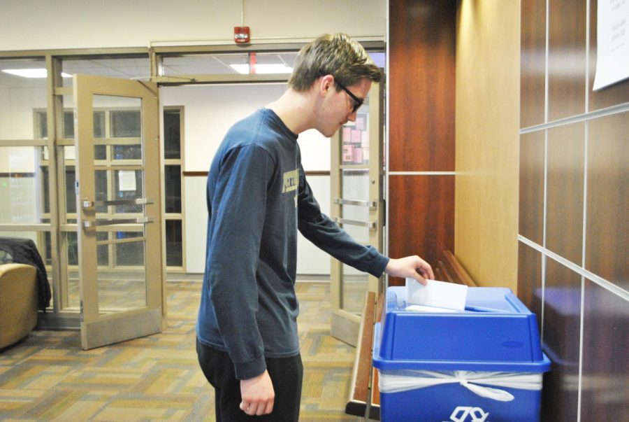 Freshman+Adam+Bambino+uses+a+recycling+bin+Friday+in+Krebs+Hall.