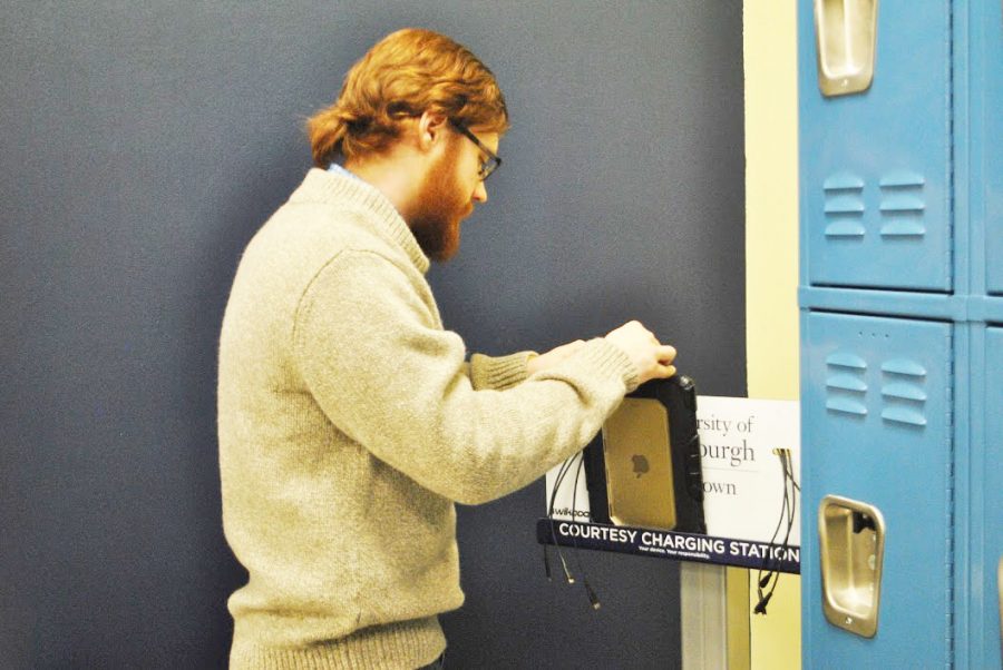 Senior+Patrick+Stahl+charges+his+iPad+at+the+charging+station+in+the+commuter+lounge+in+the+Student+Union+Feb.+1.++An+additional+charging+station+is+to+be+added+to+the+Tuck+Shop+seating+area+in+the+Student+Union+this+week.