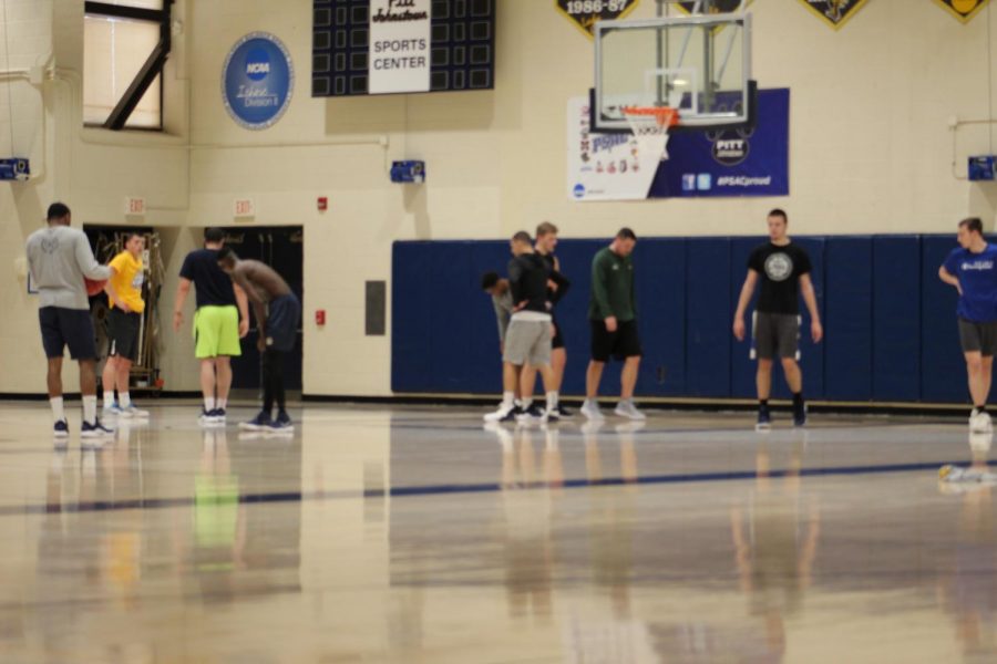 Women%E2%80%99s+head+coach+Mike+Drahos+second+from+right+helps+the+men%E2%80%99s+basketball+team+for+their+pick-up+game+in+the+Sports+Center+March+20.