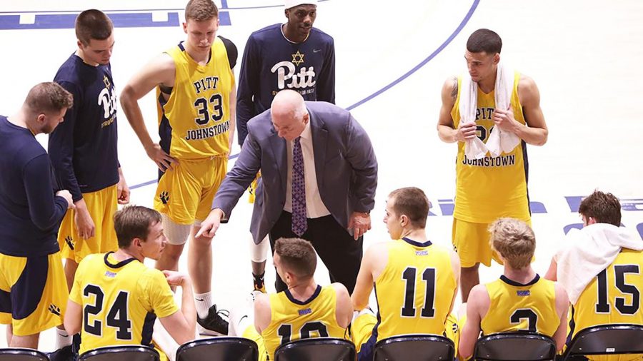 Men%E2%80%99s+basketball+head+coach+Bob+Rukavina+%28middle%29+coaches+the+Mountain+Cats+in+a+playoff+game+against+Gannon+University+March+4+at+the+Sports+Center.+Pitt-Johsntown+won+the+game%2C+70-60.
